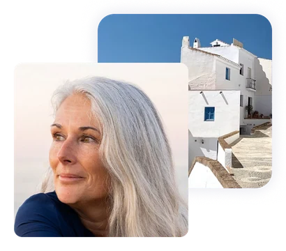 Retired American woman abroad beside a whitewashed hillside village